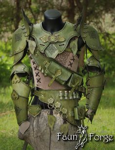 a man in green armor standing next to a tree stump with his hands on his hips