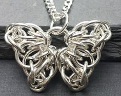 a silver butterfly pendant on a chain