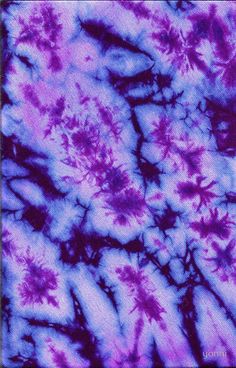 purple and blue tie dyed fabric with small white flowers on it's center piece