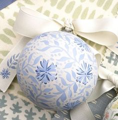 a blue and white ornament sitting on top of fabric