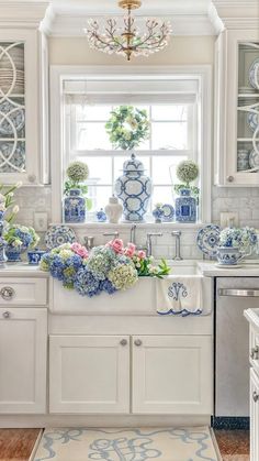 a white kitchen with blue and white decor