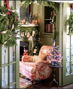 a living room decorated for christmas with wreaths