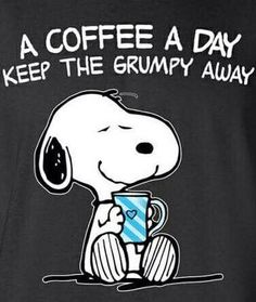 a black shirt with a snoopy holding a coffee cup in it's lap