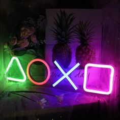 two neon signs that say xoxo and pineapples in front of them