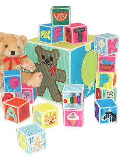 a teddy bear sitting on top of blocks with letters and numbers around it that spell out the word fit