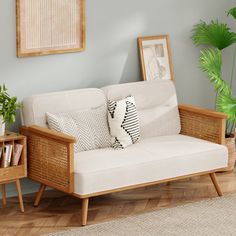 a living room scene with focus on the couch and coffee table, which is decorated in natural wood