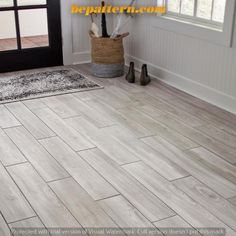 an entryway with white wood floors and black door handle on the left side of the room