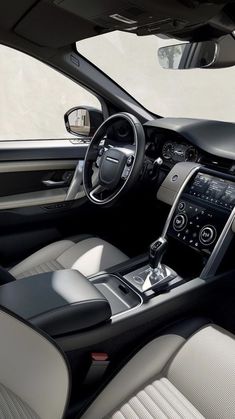 the interior of a car with leather seats and steering wheel, dash lights, and center console