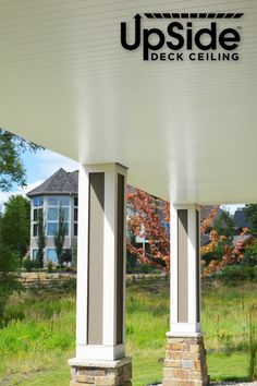 two white pillars with the words upside deck ceilings on them in front of a house