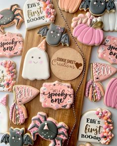 some decorated cookies are on a wooden board