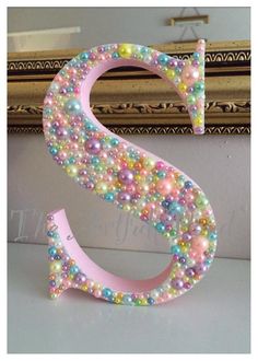 the letter s is made out of beads