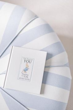 a blue and white striped chair with a card on it