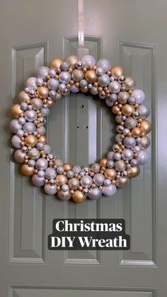 a christmas ornament wreath hanging on a door with the words, christmas diy wreath