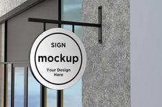 a sign hanging from the side of a building that says, sign mock up your design here