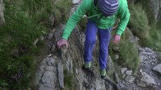 a man climbing up the side of a mountain