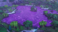 an aerial view of a purple lake surrounded by trees