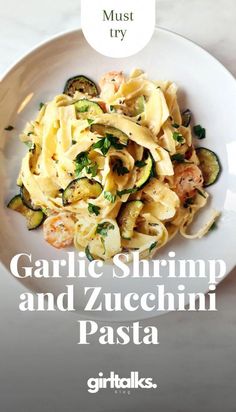 garlic shrimp and zucchini pasta on a white plate with text overlay that reads, must try garlic shrimp and zucchini pasta