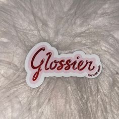 a close up of a sticker with the word glosser on it's side