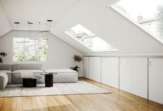 an attic living room with white furniture and wood flooring is featured in this image