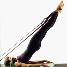 a woman is doing yoga on a mat