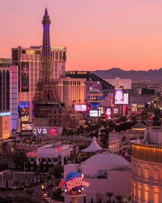 the eiffel tower is lit up at night in las vegas