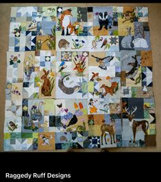 the quilt is made up of many different animals and plants, including deers, foxes, and other wildlife