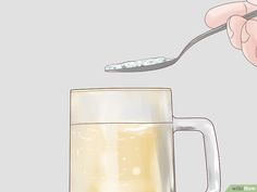 a person holding a spoon over a glass with liquid in it and the words wiki how to clean your nose plaging