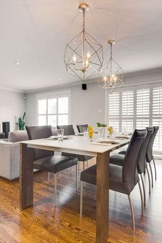 a dining room table with chairs and a chandelier