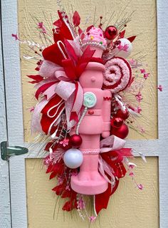 a pink and red door hanger decorated with candy