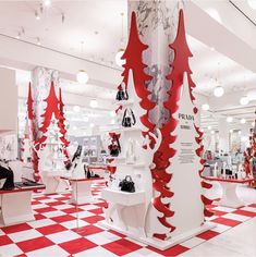 a store with red and white christmas trees on the walls, windows, and checkered flooring