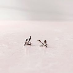 Tiny Stud Earrings: Leaves - Freshie & Zero Studio Shop Minimalist Silver Ear Climbers For Anniversary, Elegant Tiny Sterling Silver Ear Climbers, Everyday White Gold Sterling Silver Ear Climbers, Everyday Sterling Silver Ear Climbers, Minimalist Silver Leaf Earrings, Silver Leaf Minimalist Earrings, Silver Nature-inspired Everyday Earrings, Silver Everyday Nature-inspired Earrings, Silver Nature-inspired Earrings For Everyday