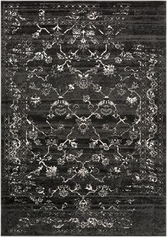 a black and white rug with an ornate design