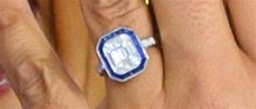 three people with rings on their fingers and one is wearing a ring that has a diamond in the middle