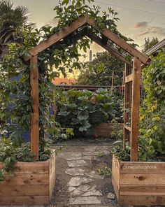 an outdoor garden with wooden planters and trelliss on the sides, surrounded by greenery