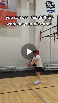 a man standing on top of a wooden floor holding a basketball in his hand and wearing white shoes