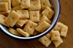 a bowl filled with cubes of food on top of a wooden table