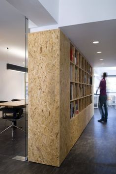 an image of a person standing in front of a book shelf that is made out of plywood