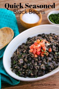 a white bowl filled with black beans and vegetables