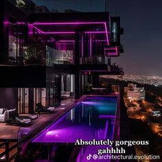 an outdoor swimming pool in front of a large building with purple lights on the side