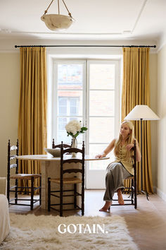 A cosy living room featuring luxurious mustard linen curtains, offering a warm, stylish accent to the space.