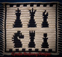 a crocheted afghan with black and white designs