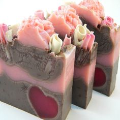 three pieces of soap with pink and brown designs