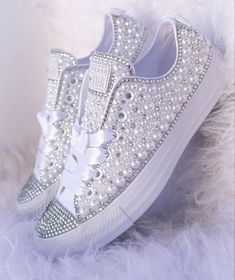 a pair of white sneakers with bows and pearls on the soles are shown in this instagram