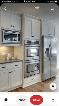 a kitchen with white cabinets and stainless steel appliance on the left side of the screen