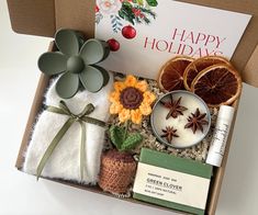 a box filled with different items including an orange, cinnamons and other holiday decorations