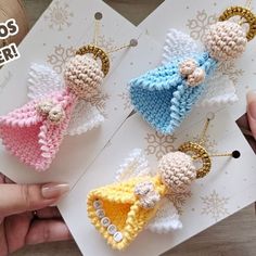 three small crocheted angel ornaments are on top of a piece of white paper