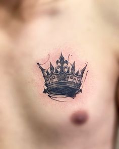 a man with a crown tattoo on his chest