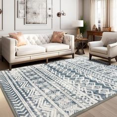 a living room with two couches and a rug on the floor in front of windows