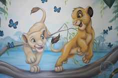 two lions playing on a tree branch in front of a mural with butterflies and butterflies