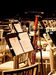 a musical instrument sitting on top of a white chair in a room filled with tables and chairs